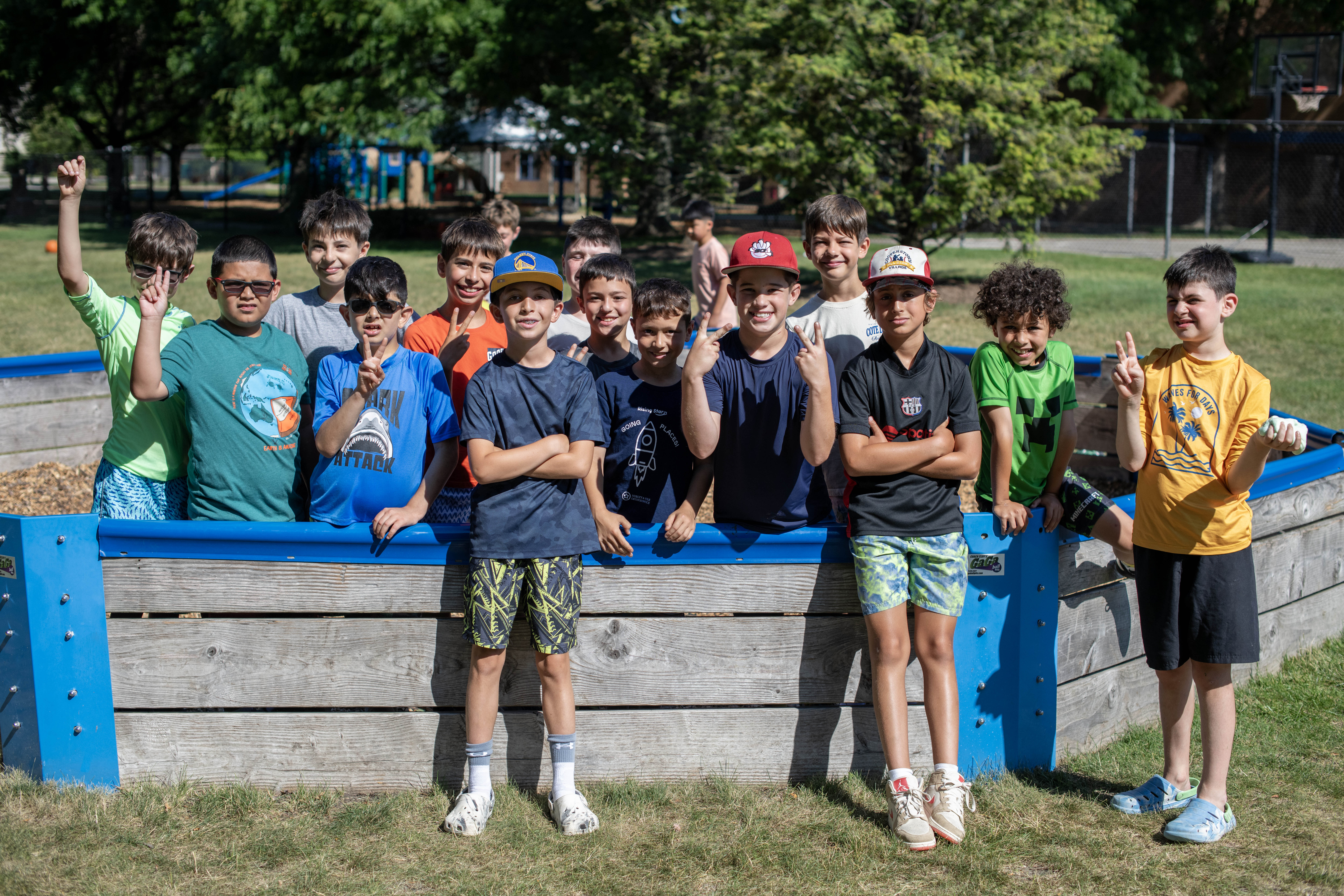 Several campers pose for a photo in a gaga pit.